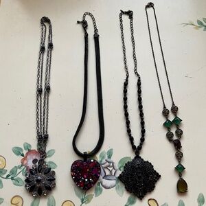 Four necklaces, black and pink.